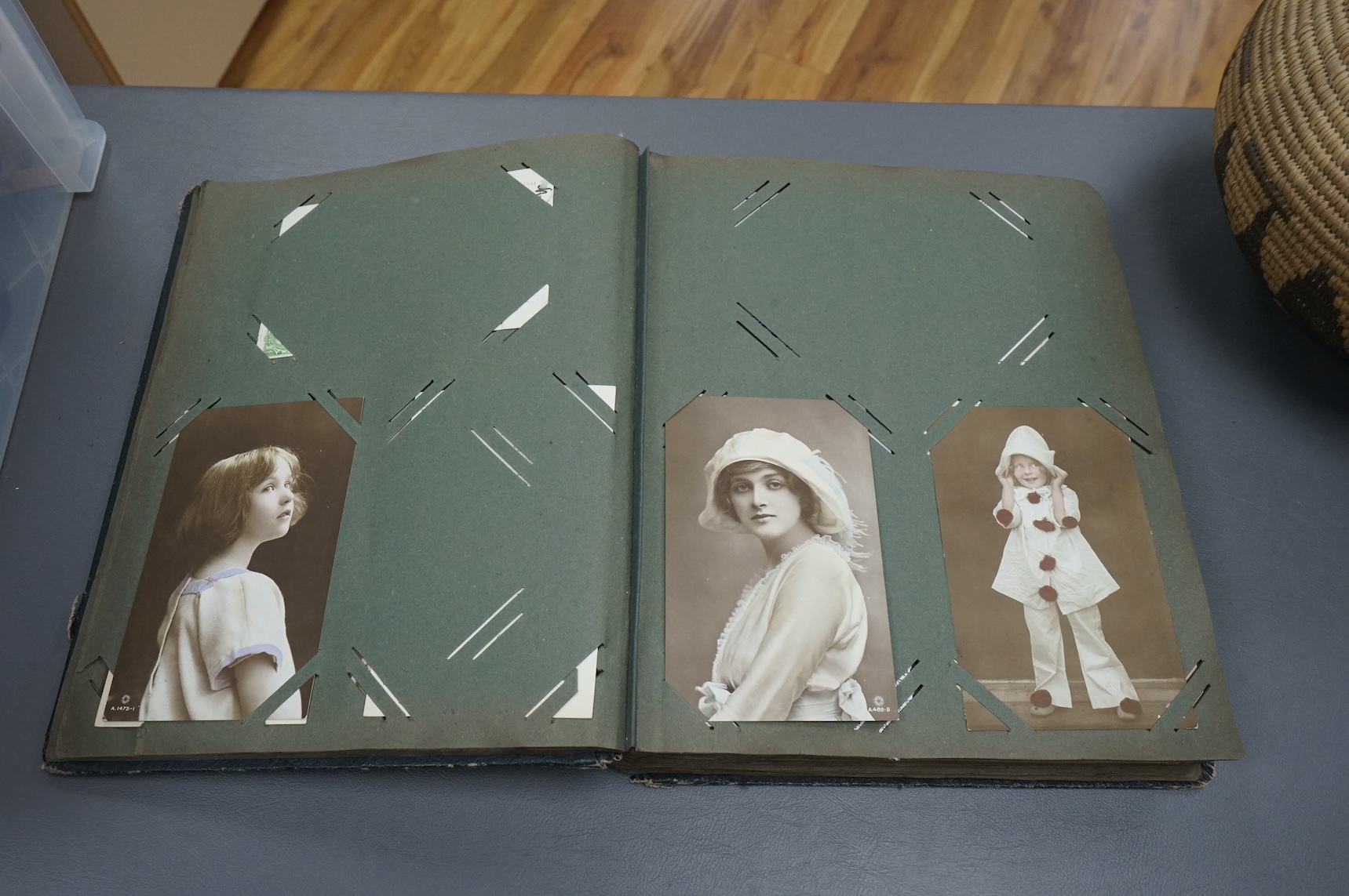 A postcard album containing early 20th century postcards, Gladys Cooper, comics, some photographs
